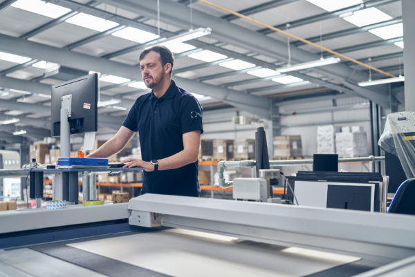 Male works checking the packaging design at the McLaren manufacturing base in Scotland